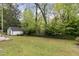 Expansive backyard with green lawn, shed, and lush landscaping, perfect for outdoor enjoyment at 431 Waddill St, Henderson, NC 27536
