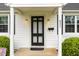 Close-up of the front door featuring the house number, black door, and decorative sconces at 431 Waddill St, Henderson, NC 27536