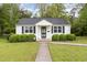 Charming home featuring a well-manicured lawn, black shutters and neatly trimmed shrubs enhancing its curb appeal at 431 Waddill St, Henderson, NC 27536