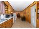 Functional kitchen featuring wood paneling, cabinets and essential appliances creating a practical space for cooking at 431 Waddill St, Henderson, NC 27536