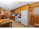 Functional kitchen with vintage cabinets, appliances, and a cozy dining area, ready for updates at 431 Waddill St, Henderson, NC 27536