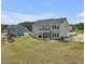Spacious backyard with covered patio, well-maintained lawn, and plenty of room for outdoor activities at 46 Twelve Oaks Dr, Willow Springs, NC 27592