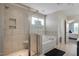Elegant bathroom featuring a tub, glass enclosed shower and neutral color palette at 46 Twelve Oaks Dr, Willow Springs, NC 27592