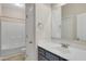 Bathroom featuring a blue vanity with a white sink and countertop and a shower-tub combo at 46 Twelve Oaks Dr, Willow Springs, NC 27592