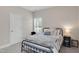 Cozy bedroom with a metal frame bed, soft bedding, and a bedside table with a lamp at 46 Twelve Oaks Dr, Willow Springs, NC 27592