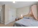 Bedroom with a white closet door and a bed with a pink canopy, creating a charming space at 46 Twelve Oaks Dr, Willow Springs, NC 27592