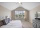 Bedroom featuring a window with multiple panels, neutral-toned walls, and a TV set, creating a cozy atmosphere at 46 Twelve Oaks Dr, Willow Springs, NC 27592
