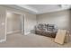 Versatile bonus room featuring a comfortable reclining sofa and carpeted flooring at 46 Twelve Oaks Dr, Willow Springs, NC 27592