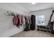 Spacious closet with ample hanging racks, shoe storage, and natural light from the window at 46 Twelve Oaks Dr, Willow Springs, NC 27592