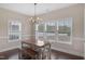Bright dining room with hardwood floors and windows overlooking the backyard at 46 Twelve Oaks Dr, Willow Springs, NC 27592