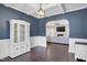 Stylish dining room featuring chair rails, dark hardwood floors, and modern lighting at 46 Twelve Oaks Dr, Willow Springs, NC 27592
