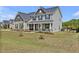 Traditional two story house featuring mature lawn, landscaping, and a welcoming front porch at 46 Twelve Oaks Dr, Willow Springs, NC 27592