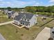 Lovely two-story home with a well-maintained lawn, mature trees, and backyard play area at 46 Twelve Oaks Dr, Willow Springs, NC 27592