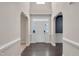 Inviting foyer with dark hardwood flooring, arched doorways, and bright white trim at 46 Twelve Oaks Dr, Willow Springs, NC 27592