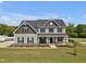 Charming two-story home with a welcoming front porch, landscaped yard, and stone accents at 46 Twelve Oaks Dr, Willow Springs, NC 27592