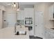 Close up of modern kitchen with stainless appliances and white cabinets, focused on quartz island at 46 Twelve Oaks Dr, Willow Springs, NC 27592
