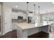Modern kitchen featuring stainless appliances, white cabinetry, and a spacious center island at 46 Twelve Oaks Dr, Willow Springs, NC 27592