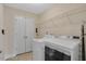 Functional laundry room with modern washer and dryer units, shelving, and storage space at 46 Twelve Oaks Dr, Willow Springs, NC 27592