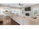 Open concept living room with fireplace, windows, and seamless flow into the kitchen and dining area at 46 Twelve Oaks Dr, Willow Springs, NC 27592