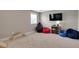 Kid-friendly playroom with a TV, gaming chair, beanbags, and carpeted floors at 46 Twelve Oaks Dr, Willow Springs, NC 27592