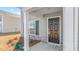 The home boasts a welcoming front porch with stone accents and a dark wood door at 494 Lochalsh Dr, Gibsonville, NC 27249