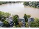 A beautiful lake view behind a house with big yard and mature trees and grass at 512 N Waters Edge Dr, Durham, NC 27703
