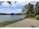 Scenic view of a backyard with a patio overlooking a serene lake, blending natural beauty with outdoor living space at 512 N Waters Edge Dr, Durham, NC 27703