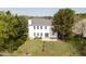 Aerial view of a home with a large backyard, including a patio, mature trees, and lush green space at 512 N Waters Edge Dr, Durham, NC 27703