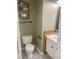 Stylish half bathroom with patterned tile flooring and modern fixtures and decorative shelves and rustic wood accent panel at 512 N Waters Edge Dr, Durham, NC 27703