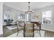 Dining area with vaulted ceilings, elegant chandelier, and seamless flow to living space at 512 N Waters Edge Dr, Durham, NC 27703