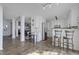 Bright, modern kitchen with white cabinetry, stainless steel appliances, and counter seating overlooking the living area at 512 N Waters Edge Dr, Durham, NC 27703