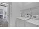 Clean laundry room with a laundry machines, door to the outside, and practical shelving for storage at 512 N Waters Edge Dr, Durham, NC 27703