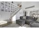 Spacious living room featuring a staircase, photo wall, and comfortable gray sectional at 512 N Waters Edge Dr, Durham, NC 27703