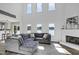 Bright, open living area with high ceilings, a fireplace, large sectional, and stunning lake views at 512 N Waters Edge Dr, Durham, NC 27703
