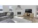 Cozy living room with a fireplace, gray sofa, and lake views through a window at 512 N Waters Edge Dr, Durham, NC 27703