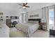 Spacious main bedroom with a tray ceiling, large windows, and a dedicated workspace at 512 N Waters Edge Dr, Durham, NC 27703