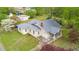 Aerial view of a cream-colored home featuring a metal roof and well-manicured lawn at 516 W Fourth St, Siler City, NC 27344