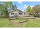 View of the home's backyard, complete with a grill and patio area at 516 W Fourth St, Siler City, NC 27344