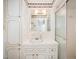 Bright bathroom with tiled countertop, vanity and shower-tub combo with glass doors at 516 W Fourth St, Siler City, NC 27344