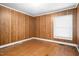 Bedroom with wood paneled walls, a neutral ceiling, and bright, natural lighting at 516 W Fourth St, Siler City, NC 27344