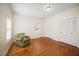 Light and bright bedroom with wood floors, chair, and double door closets for storage at 516 W Fourth St, Siler City, NC 27344