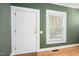 Green painted entryway with a white door, trim and window at 516 W Fourth St, Siler City, NC 27344