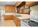 Bright kitchen featuring a double sink, window with wooden shutters, and electric range at 516 W Fourth St, Siler City, NC 27344