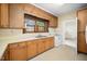 The kitchen includes ample cabinets, a double sink, white appliances and a window at 516 W Fourth St, Siler City, NC 27344