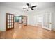 Spacious living room with hardwood floors, ceiling fan, and glass paneled doors at 516 W Fourth St, Siler City, NC 27344