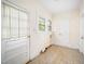 Bright utility room featuring a door to outside, windows and a unique tile floor at 516 W Fourth St, Siler City, NC 27344