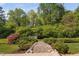 Landscaped backyard featuring a beautiful stone pathway leading to a small chicken coop at 521 Wildwood Farm Way, Holly Springs, NC 27540