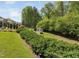 Well-maintained backyard featuring lush landscaping and a manicured lawn at 521 Wildwood Farm Way, Holly Springs, NC 27540