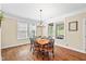 Cozy dining area with natural light and hardwood floors at 521 Wildwood Farm Way, Holly Springs, NC 27540