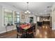 Open concept dining area with hardwood floors, a view of the kitchen, and a fireplace at 521 Wildwood Farm Way, Holly Springs, NC 27540